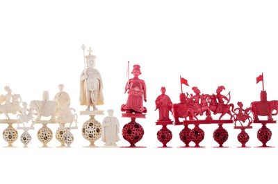 Lot 869A - A CHINESE CARVED NATURAL AND STAINED IVORY CHESS SET