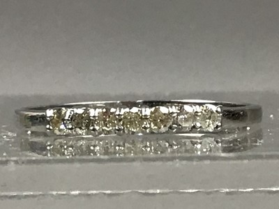 Lot 55 - A PLATINUM AND DIAMOND SEVEN STONE RING